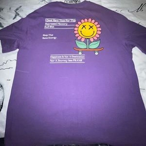 Here I am selling a purple graphic shirt .